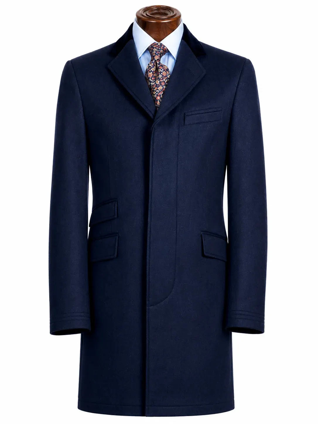 Navy chesterfield overcoat with a velvet collar, fly front, welt chest pocket and flap pockets.