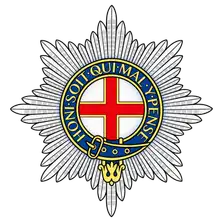 Coldstream Guards cap star: the Star of the Order of the Garter with a red St George's cross and Garter motto.