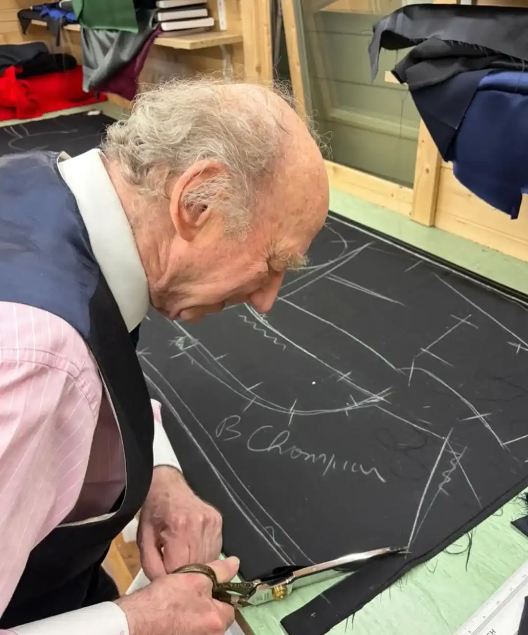Geoffrey Golding cutting cloth in the new St Albans workroom