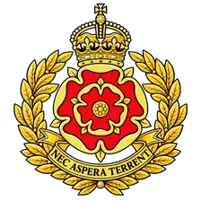 Regimental cap badge: the Red Rose of Lancaster in a gold laurel wreath beneath a crown, on a Nec Aspera Terrent scroll.