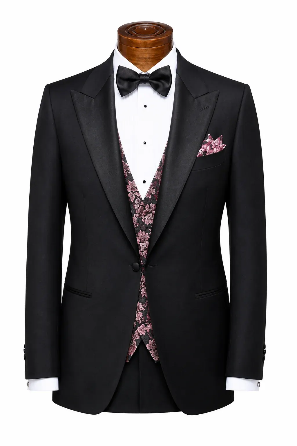 Black dinner jacket with silk-faced peak lapels and a one-button front, over a pink floral evening waistcoat.