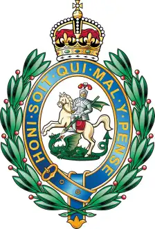 Fusiliers cap badge: St George and the dragon within the Garter, with a crown above and laurel wreath.