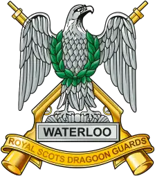 Royal Scots Dragoon Guards cap badge: a silver-plated eagle on a laurelled plume inscribed WATERLOO, over gilt crossed carbines and the regimental-title scroll.