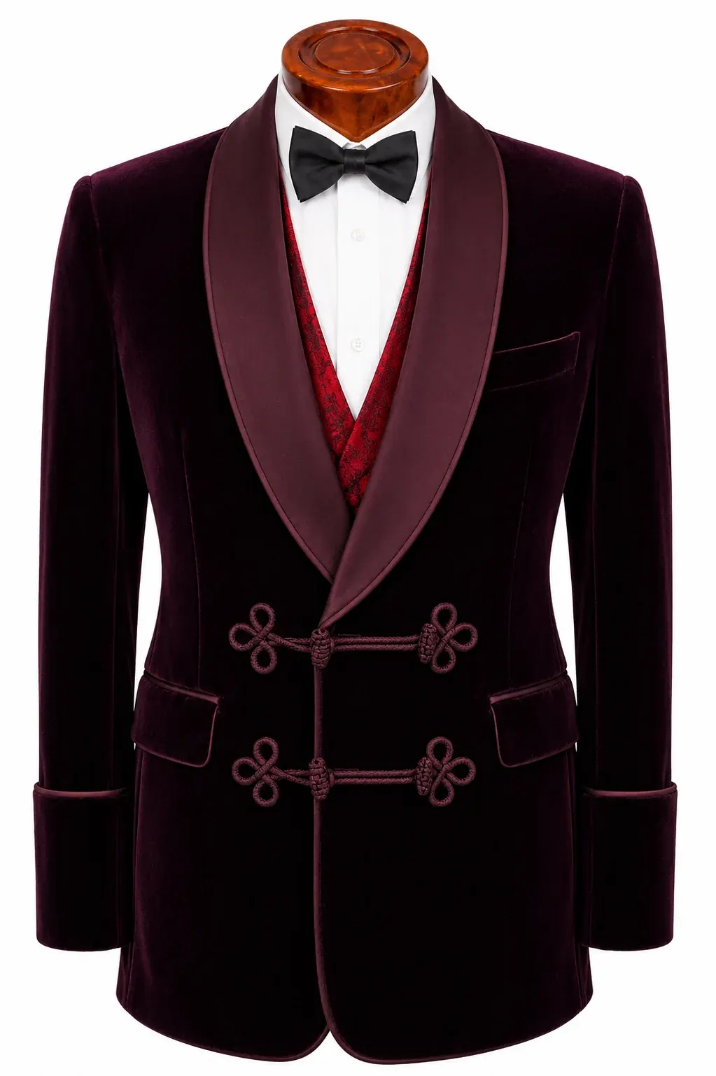 Burgundy velvet smoking jacket with a silk shawl collar, cord frogging and turn-back cuffs, over a red waistcoat.