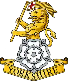 The Royal Yorkshire Regiment badge: a gold lion holding a St George's banner above a white rose and YORKSHIRE scroll.